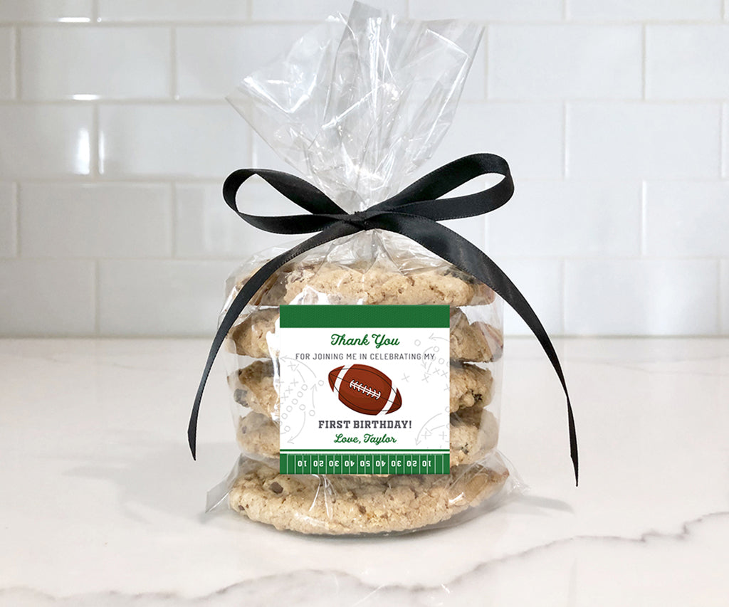 Football first birthday square favor tag on bag of cookies.
