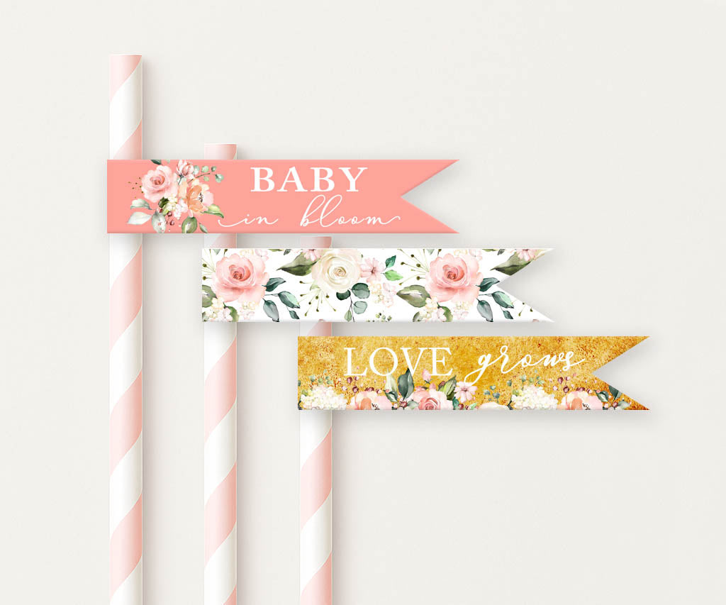 Three decorative baby shower straw flags on pink striped straws, showing watercolor floral patterns and elegant scripted messages in a Baby in Bloom theme.