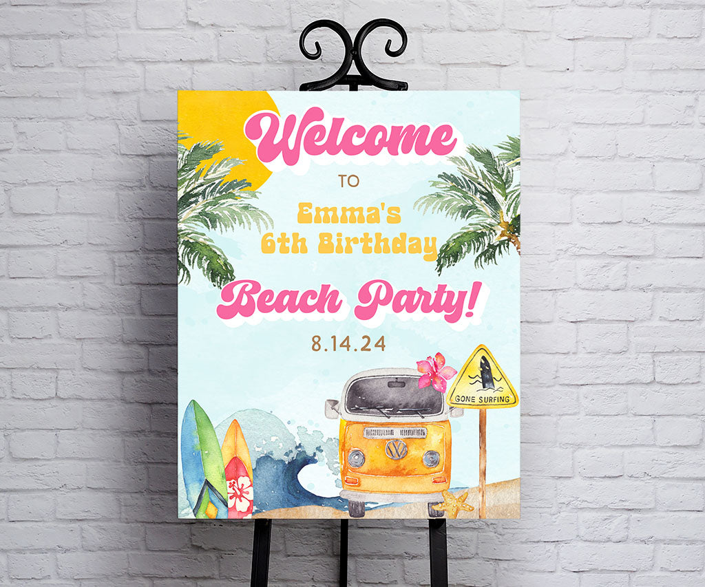 Beach and surf theme birthday party welcome sign in pink, yellow and blue with ocean waves, surf boards, beach van and tropical trees.