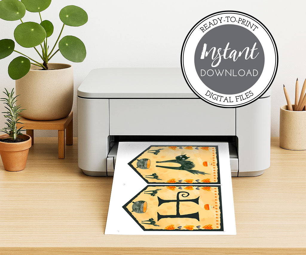 Happy Halloween banner on a home printer with black cats, cauldron, whimsical hearts and potion bottle.