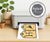 Happy Halloween banner on a home printer with black cats, cauldron, whimsical hearts and potion bottle.
