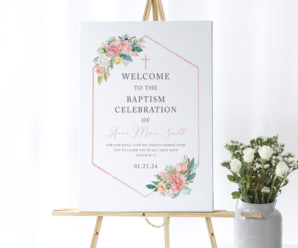 Floral baptism welcome sign on easel with pink white and yellow flowers.