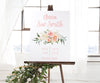 pink and white floral birth stats sign on easel