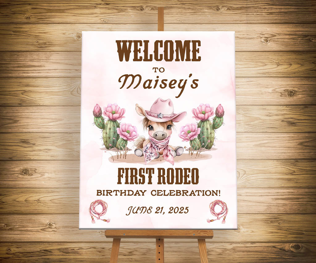 Girl's first rodeo birthday welcome sign with cute pony in pink cowgirl hat and flowering cacti.