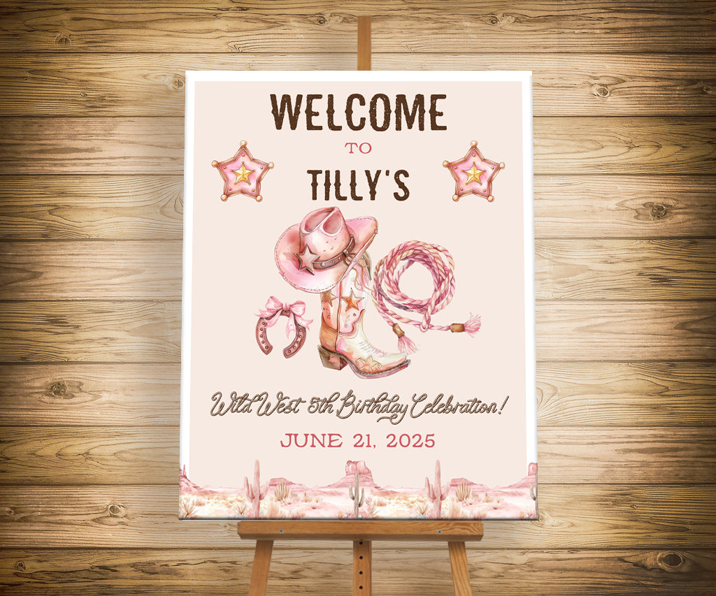 Pink and brown western cowgirl birthday welcome sign featuring cowgirl hat, boot, lasso and horseshoe.