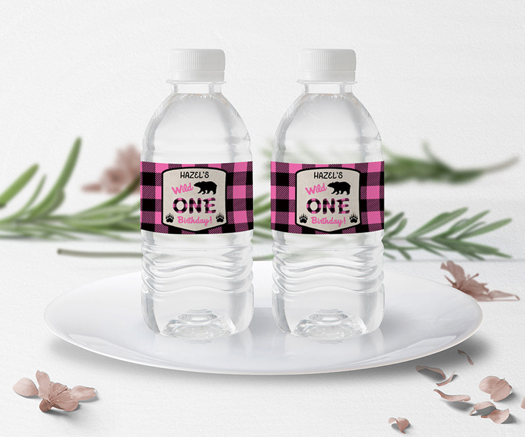 Pink buffalo plaid Wild One birthday party water bottle wrappers.