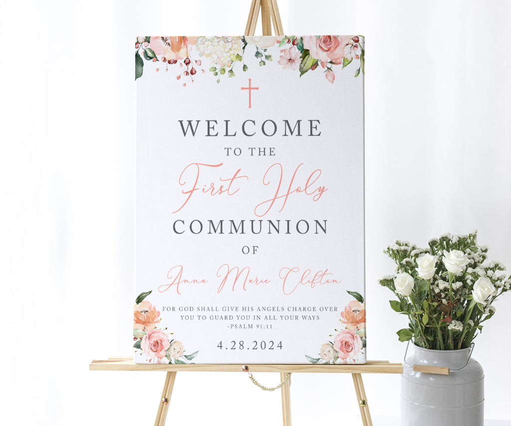 Pink and white first holy communion welcome sign on an easel.