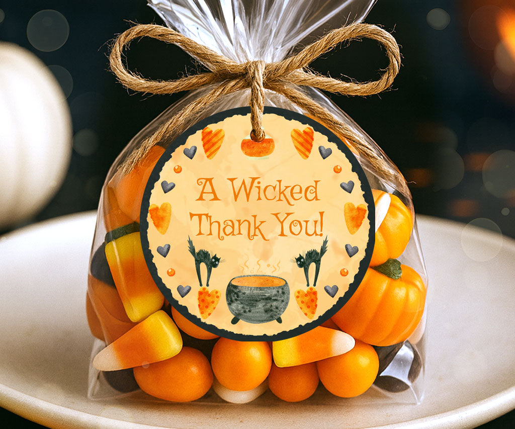 Round Halloween favor tag with a cauldron and black cats.