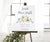 white floral birth stats sign on an easel