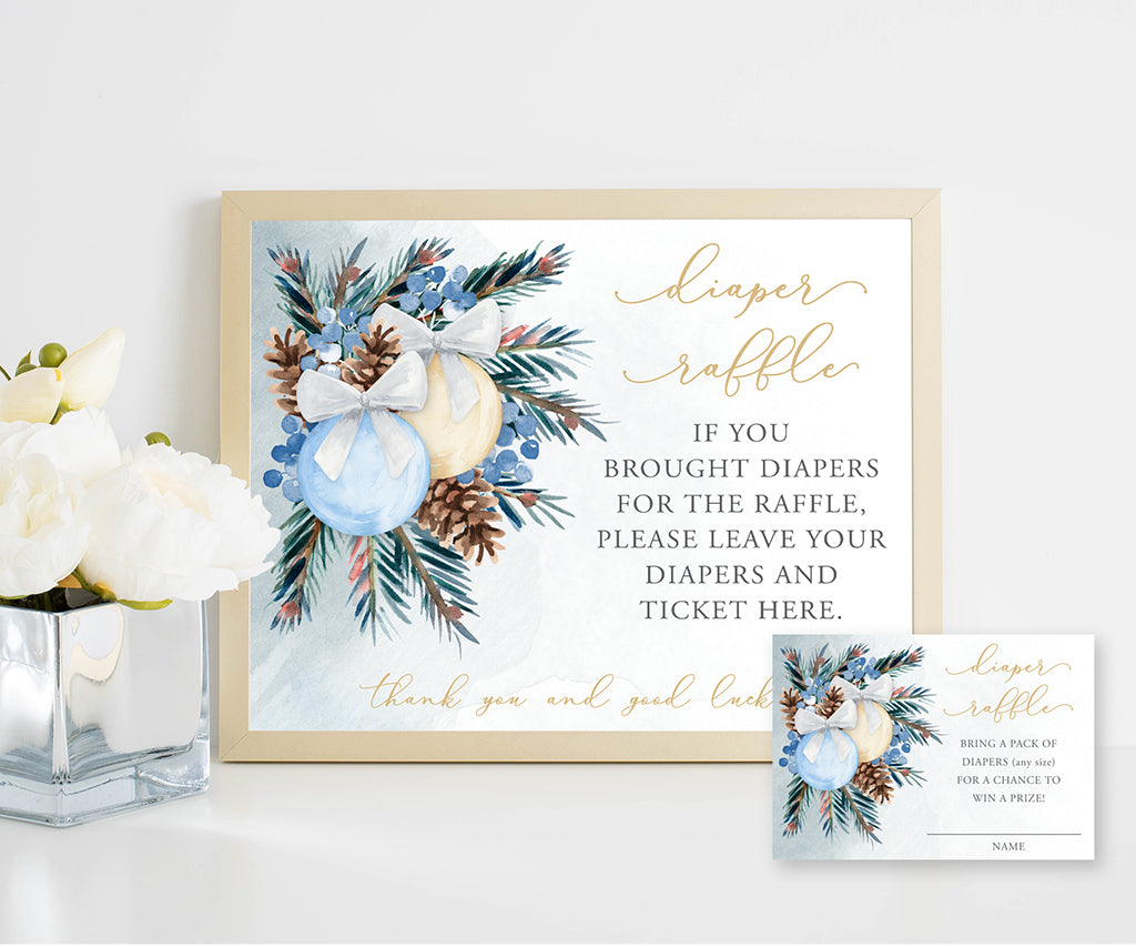 Winter baby shower diaper raffle sign and entry ticket with blue and gold holiday ornaments and pine greenery for a Christmas time baby shower.