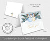Winter baby shower folded thank you card with blue and gold ornaments and pine greenery.