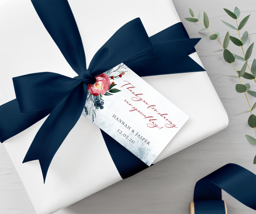 horizontal winter wedding favor tag with pine greenery and red flower