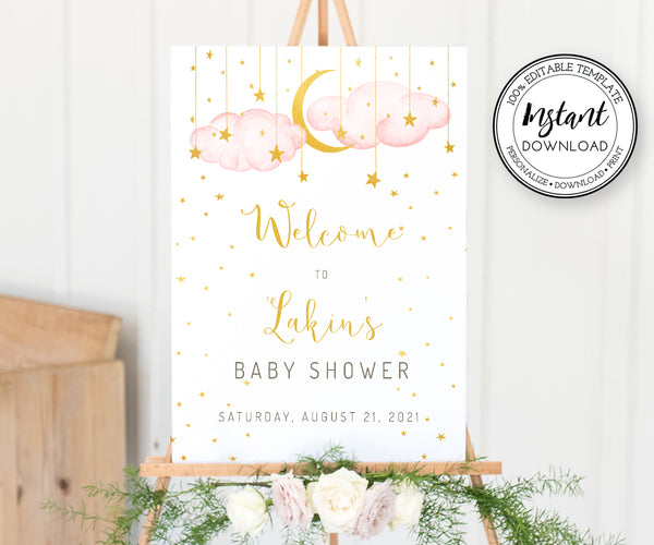Twinkle twinkle little star, girl baby shower welcome sign. Sign has pink clouds with gold moon and stars. Welcome text is gold scipt. Baby Shower welcome sign is shown on an easel with flowers at the bottom.