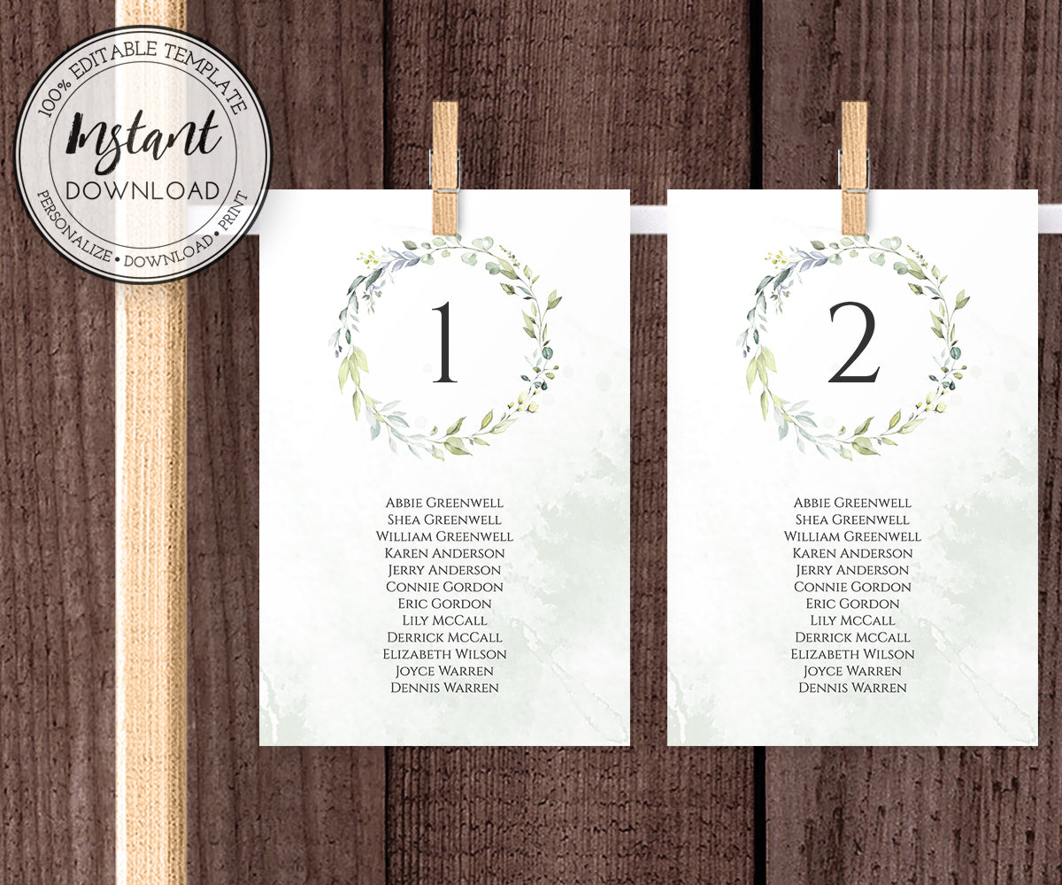 Greenery wedding seating chart cards clipped onto wooden frame
