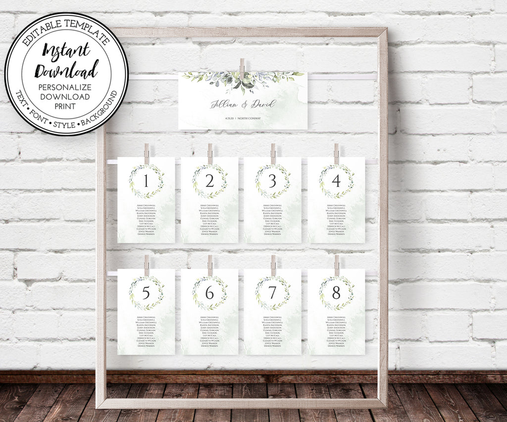 Greenery wedding seating chart with header and cards clipped onto a wooden frame display