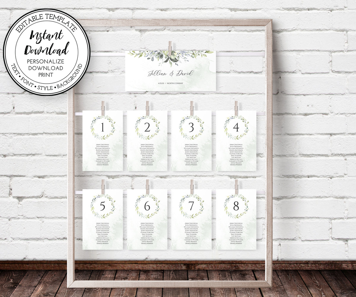 Greenery wedding seating chart with header and cards clipped onto a wooden frame display